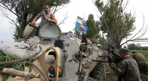 Ukraińscy żołnierze usprawniają swój pojazd opancerzony w bazie w pobliżu Izium