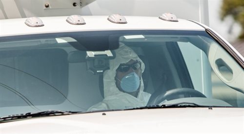 Kierowca karetki w ubraniu ochronnym i masce przewozi Nancy Writebol z bazy sił powietrznych Dobbins do szpitala Uniwersytetu Emory w Atlancie, gdzie zostanie poddana leczeniu