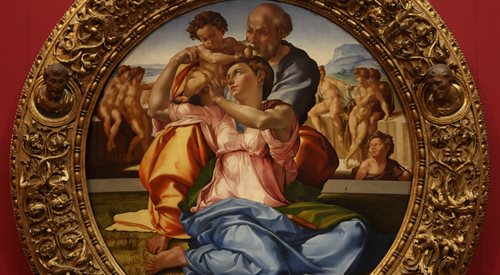 Fragment obrazu Tondo Doni wraz z ramą na ścianie Galerii Uffizi we Florencji